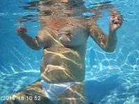 A big ass slut swims topless