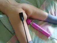 Young little girl having fun with a vibrator and receiving blows in the ass