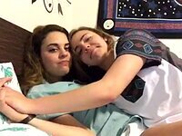 Young girlfriends kiss on camera
