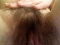 Cute brunette shows off her hairy pussy