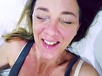 My warm cum drips down her smiling face.