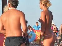 Topless bikini girl talking to the guy paying no attention he is staring at her boobs