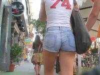 The cameraman was strolling around the city recording amateurs in the hot jeans shorts